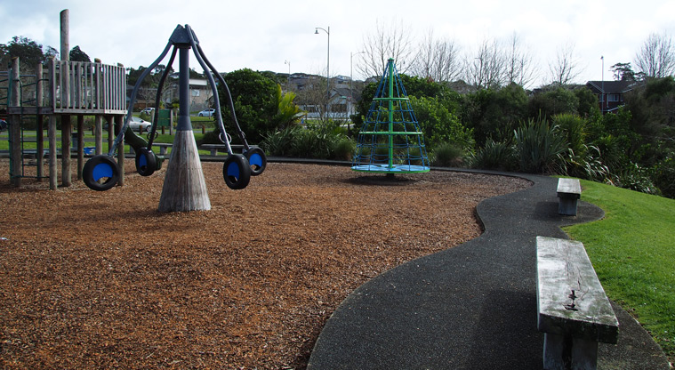 Xena Park - Wooden benches line a path next to the spinning pole and climbing tower. Photo credit: Tracey Hodder.