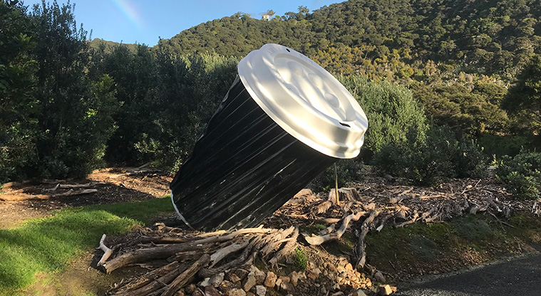 Okoka Beach Path - Large coffee cup sculpture on the section through the Dead Dog Bay sculpture park.