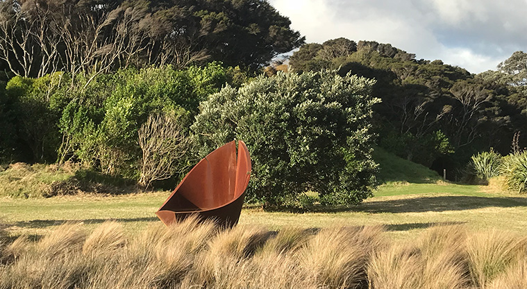 Okoka Beach Path - The saltmarsh plants (oioi) grow on the edge of where the salt water reaches. The sculpture is made by David McCracken - look for his trademark crack!